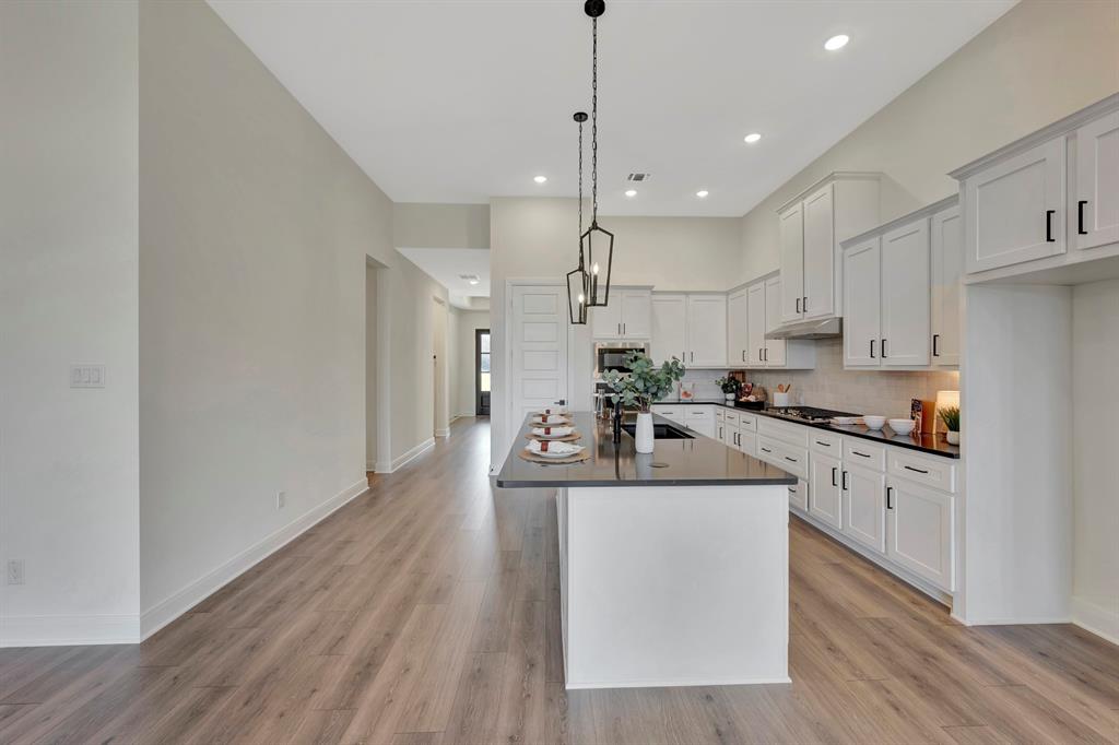 2901 Long Trail Mansfield, TX 76063 - Photo 17 of 28 a kitchen with kitchen island a white counter top space cabinets and stainless steel appliances
