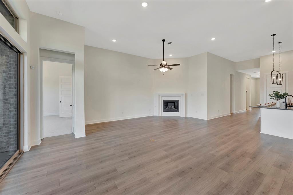 2901 Long Trail Mansfield, TX 76063 - Photo 6 of 28 a view of empty room with wooden floor and kitchen view