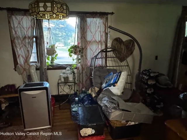 a living room with furniture and a floor to ceiling window