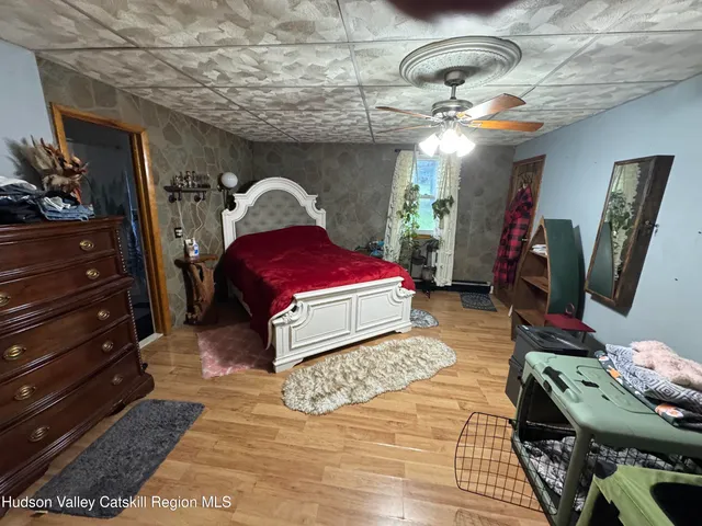 a bed room with a bed and a mirror