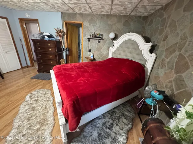 a bed sitting in a bedroom next to a window
