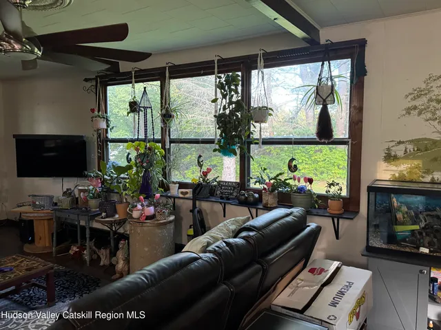 a living room with fireplace furniture and a flat screen tv