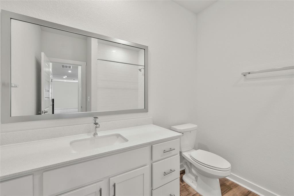 113 Shadow Oak Cove Georgetown, TX 78628 - Photo 32 of 40 A well-appointed bathroom features a crisp white vanity and a bright, reflective mirror.