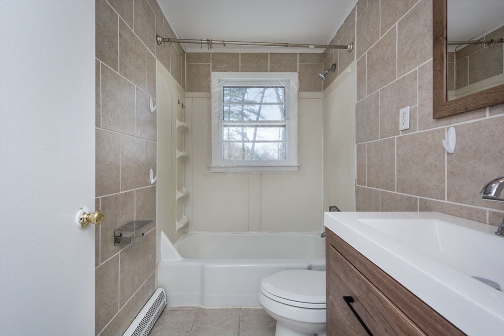 22 Southwest Cutoff, Unit C Northborough, MA 01532 - Photo 14 of 14 a bathroom with a granite countertop bathtub shower sink vanity and toilet