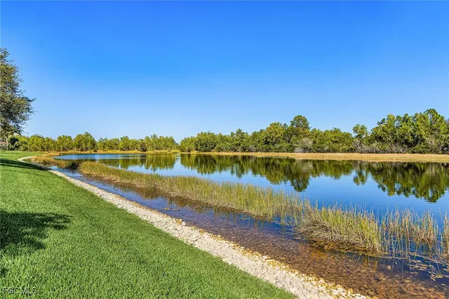 a view of a lake with houses in the back