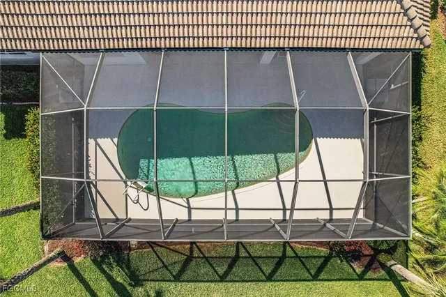 an aerial view of residential houses with outdoor space and trees