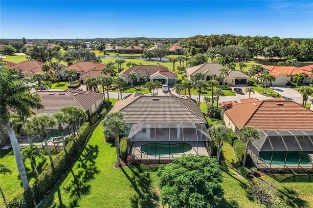 an aerial view of residential houses with outdoor space and ocean view