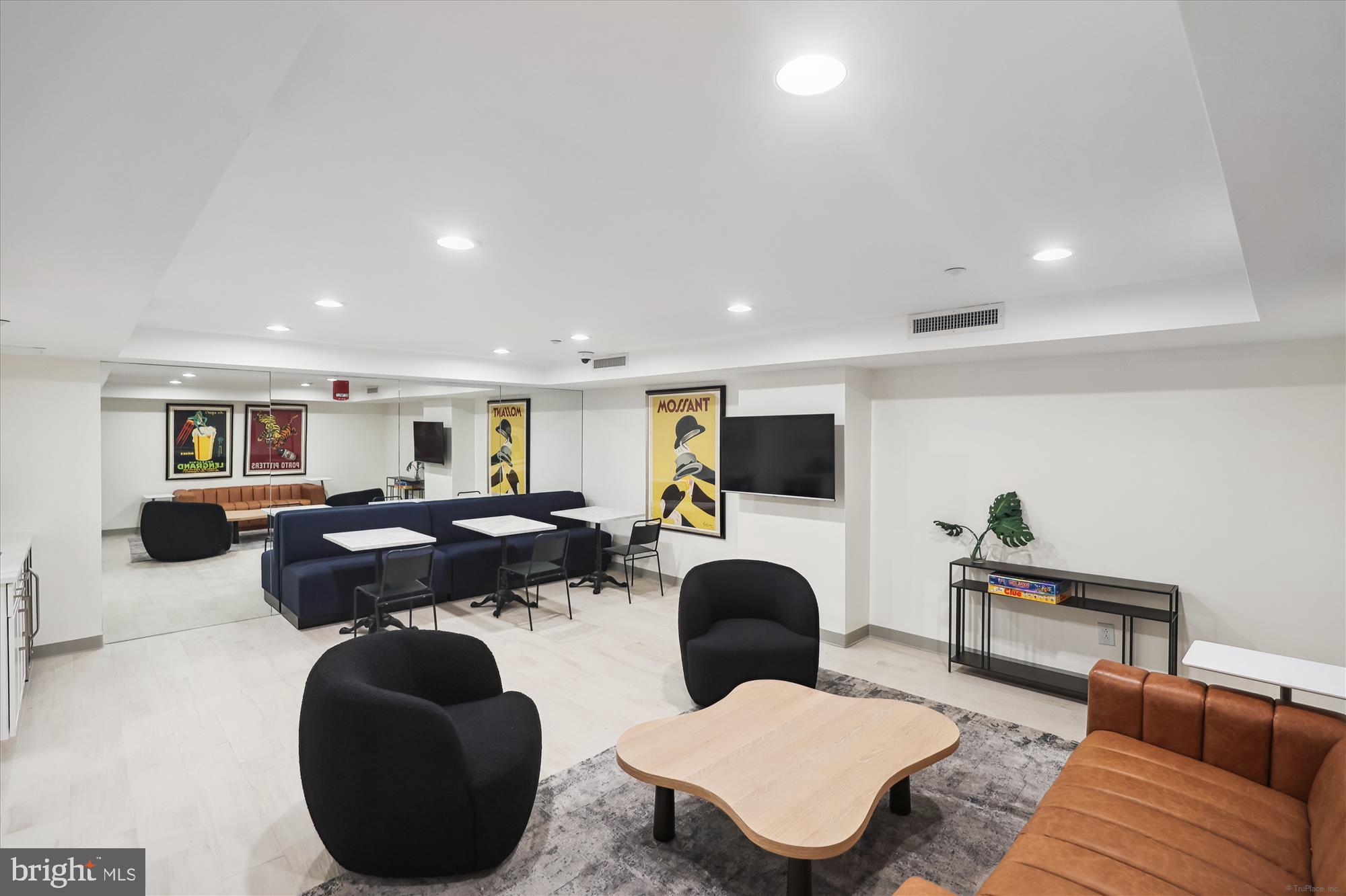 1150 K Street Northwest, Unit 706 Washington, DC 20005 - Photo 31 of 34 a living room with furniture a flat screen tv and kitchen view