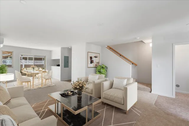 a living room with furniture and wooden floor