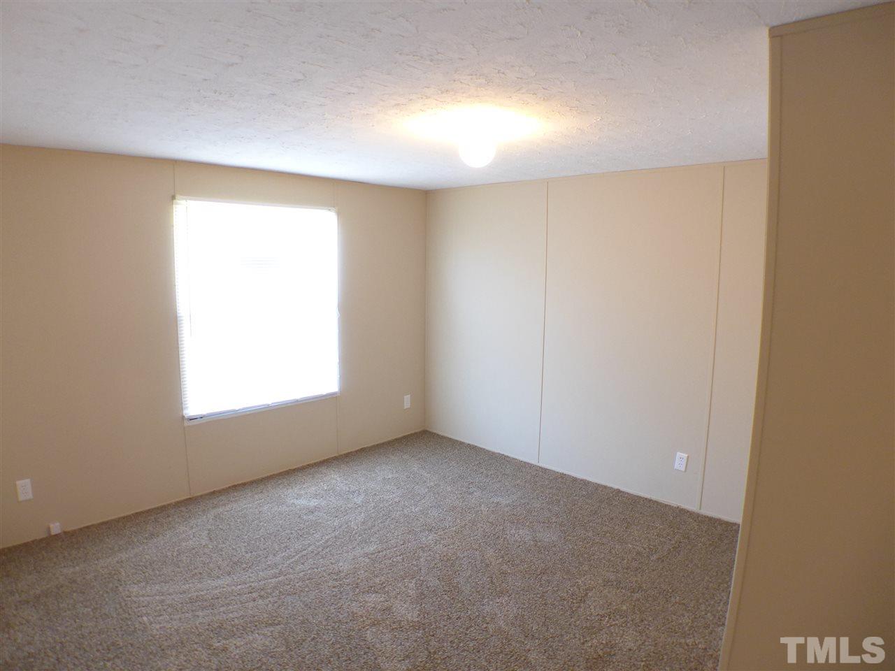 7515 Bill Love Road Willow Spring, NC 27592 - Photo 15 of 20 an empty room with a window