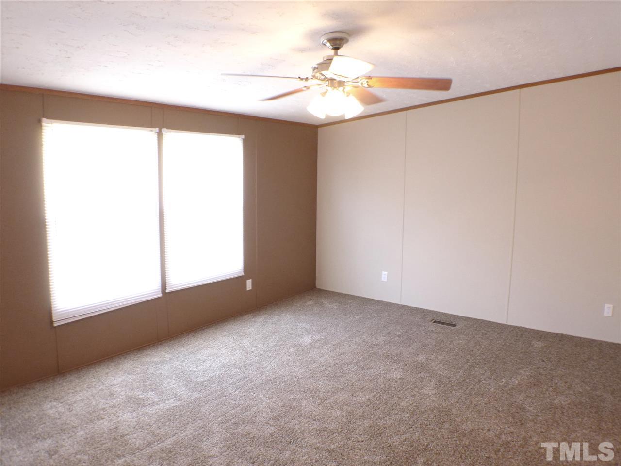 7515 Bill Love Road Willow Spring, NC 27592 - Photo 8 of 20 an empty room with a window