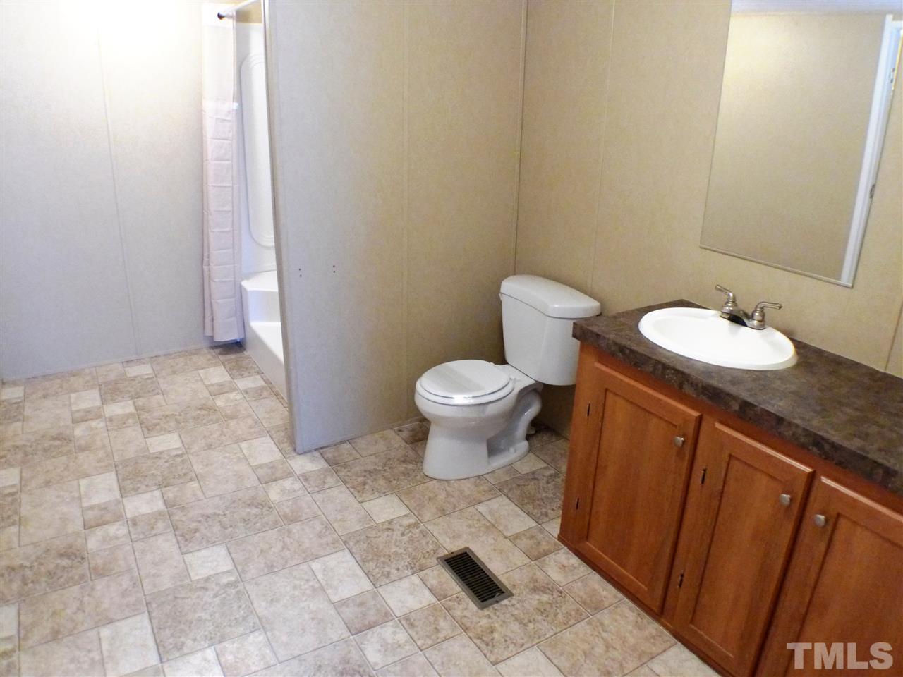 7515 Bill Love Road Willow Spring, NC 27592 - Photo 9 of 20 a bathroom with a sink and a toilet