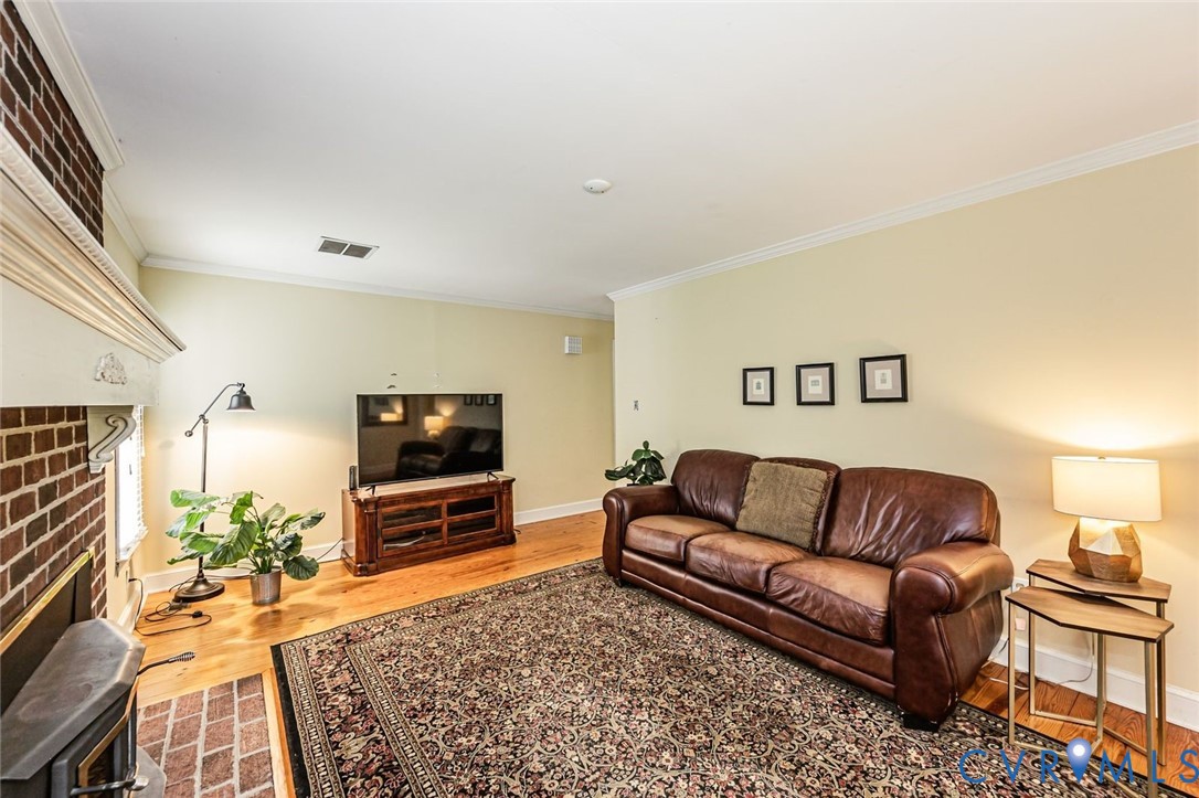 7300 Old Roxbury Road Quinton, VA 23141 - Photo 22 of 89 Brick fireplace with a wood mantel, wood-finish fl