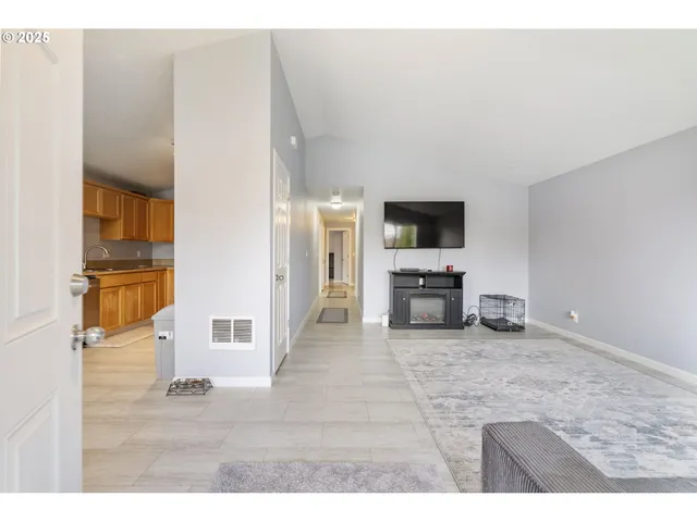 a view of a livingroom with furniture and a flat screen tv
