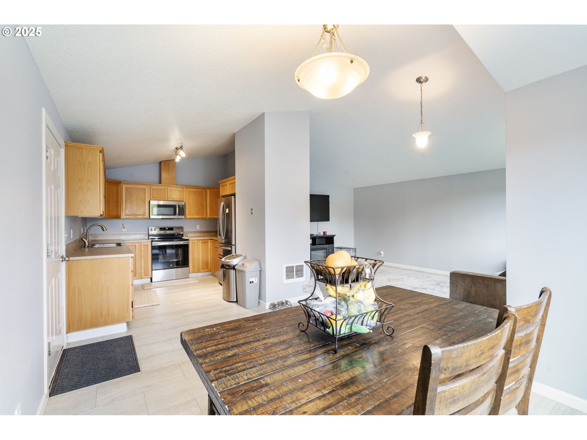 453 North 11th Street St. Helens, OR 97051 - Photo 3 of 20 a living room with dining table a table and kitchen view