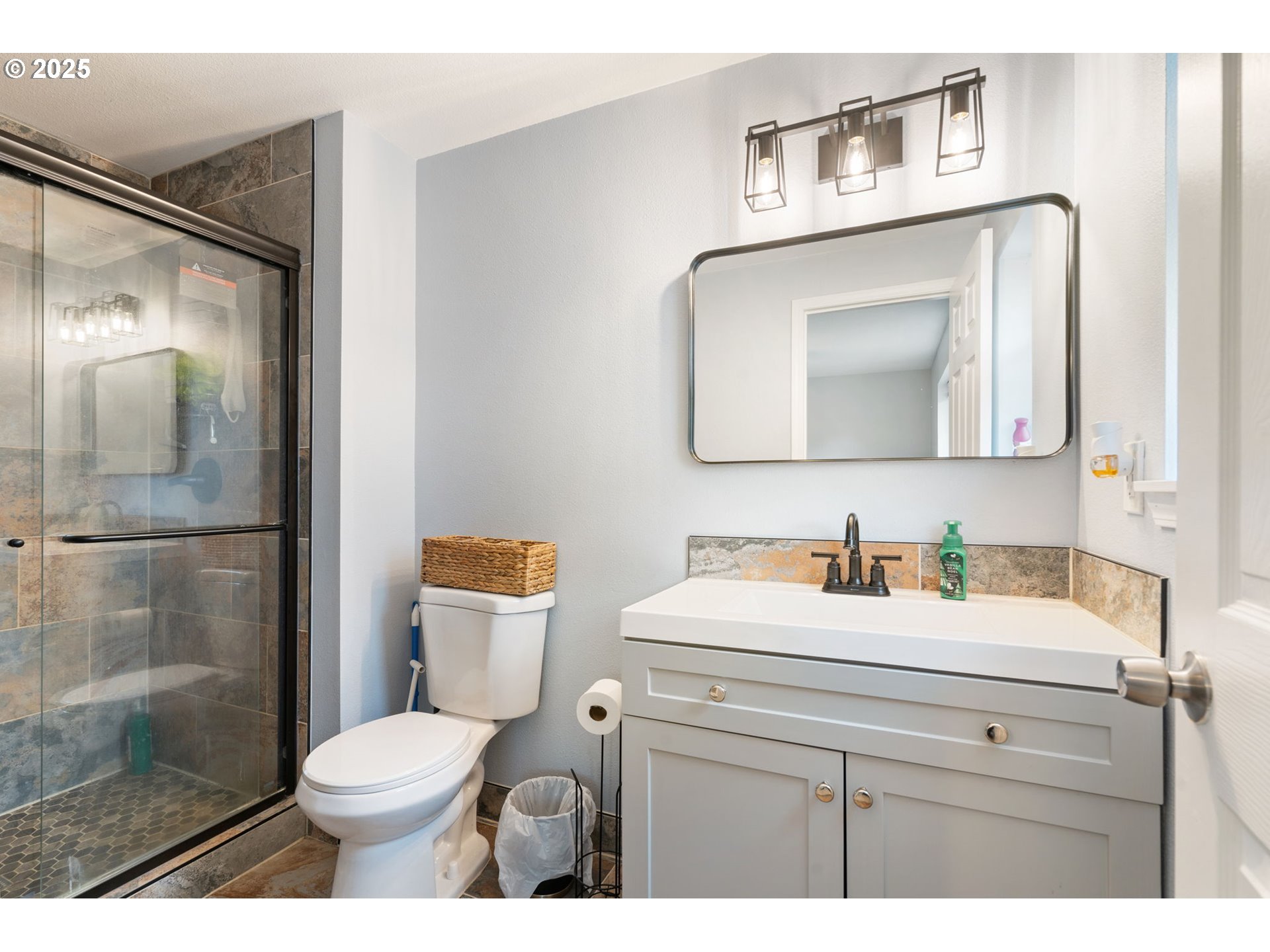 453 North 11th Street St. Helens, OR 97051 - Photo 9 of 20 a bathroom with a toilet sink vanity and mirror
