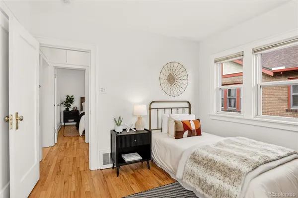 a bedroom with a bed and a wooden floor