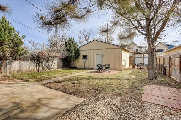 a view of a yard with a house and a large tree