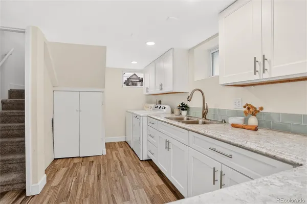 a kitchen with sink and cabinets
