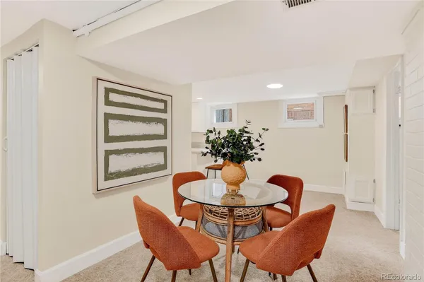 a dining room with furniture and window