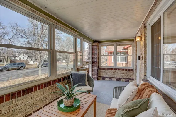 a living room with furniture and large windows