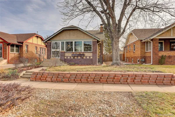 a front view of a house with a yard covered with snow in front of house