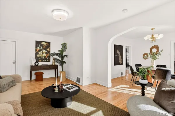 a living room with furniture and wooden floor