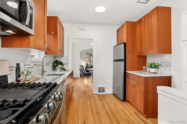 a kitchen with a stove a sink and a refrigerator