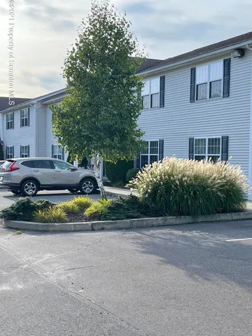 a view of a house with a backyard and plants