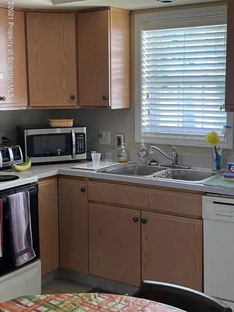 a kitchen with sink and cabinets