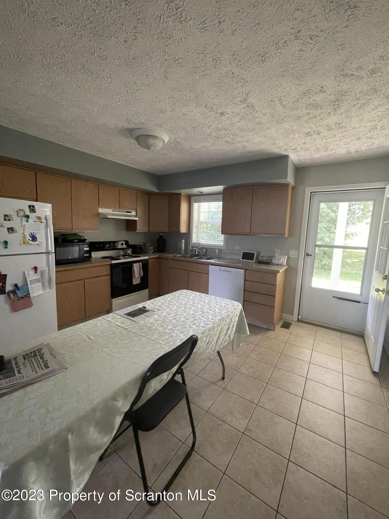 628 Marion Lane Moosic, PA 18507 - Photo 10 of 10 a kitchen with stainless steel appliances granite countertop a stove a sink a microwave and a refrigerator