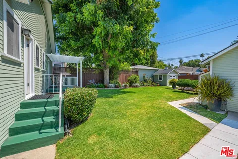 a view of house that has a yard