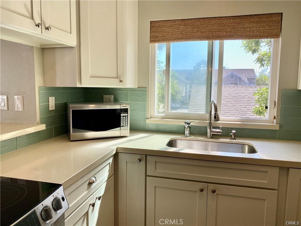 34026 Selva Road, Unit 69 Dana Point, CA 92629 - Photo 3 of 10 a kitchen with stainless steel appliances granite countertop a sink and a microwave
