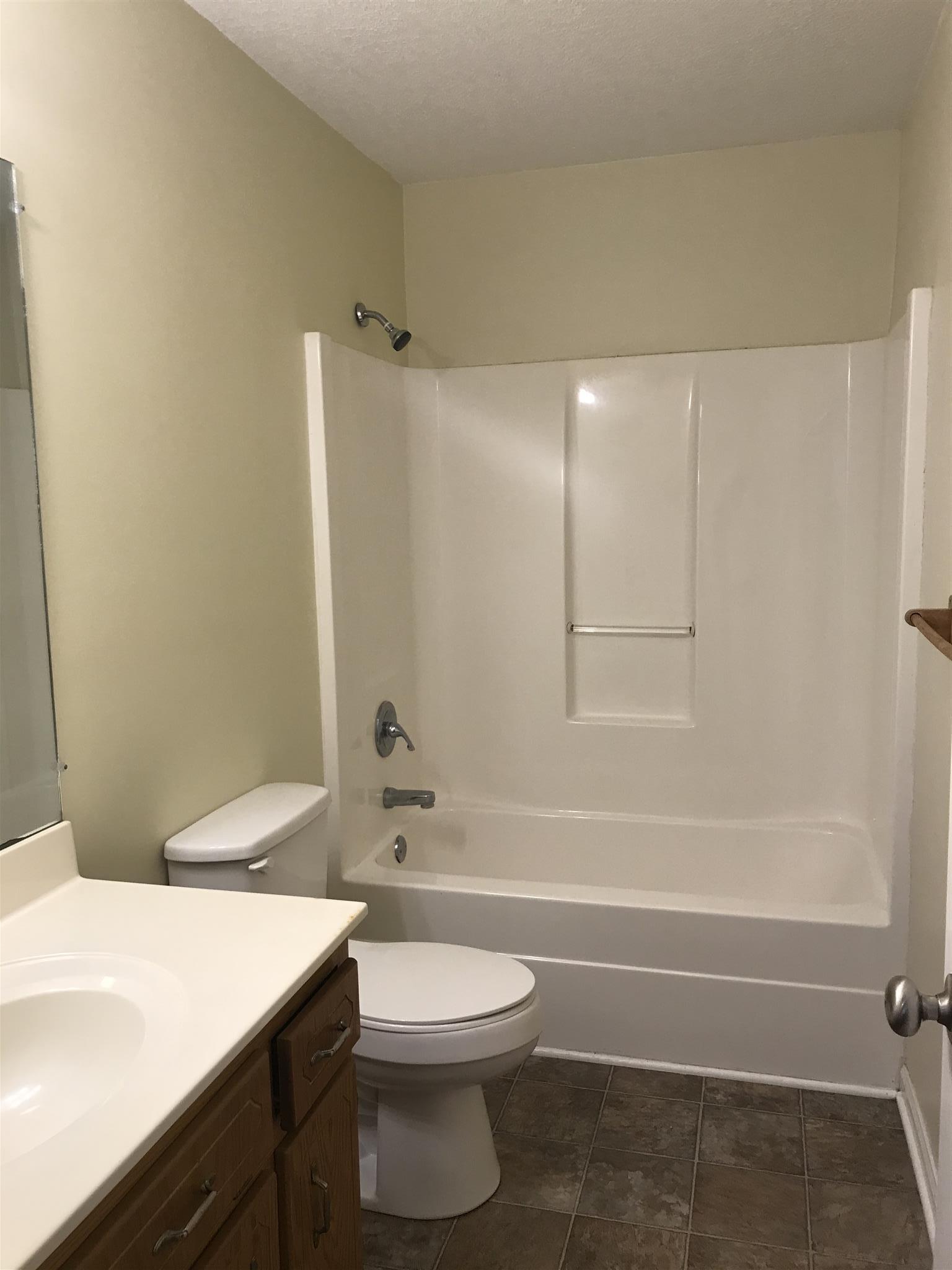 957 Shelly Road Decherd, TN 37324 - Photo 12 of 16 a bathroom with a toilet a sink and a bathtub