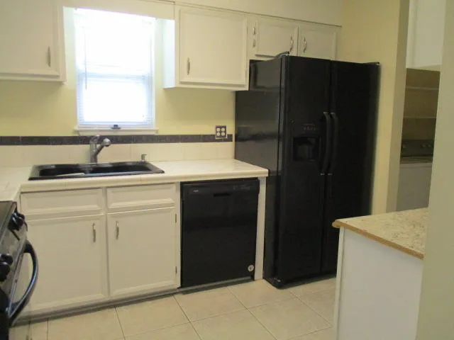 a kitchen with a sink and a refrigerator