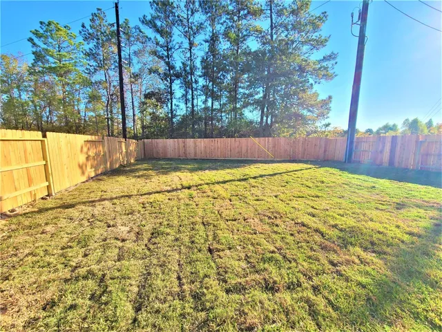a view of swimming pool with wooden fence