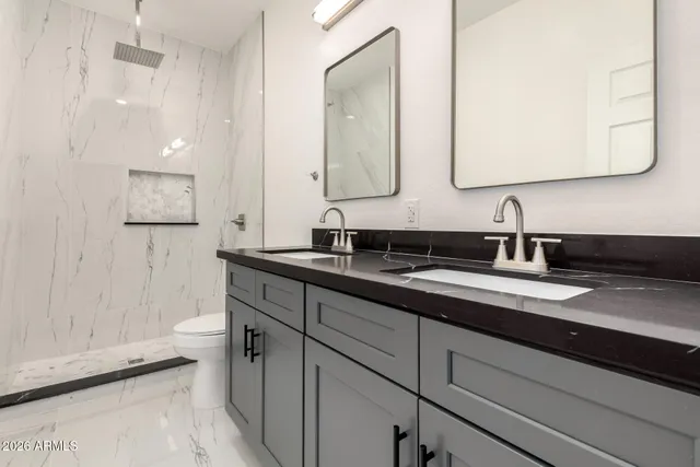 a bathroom with a double vanity sink and mirror