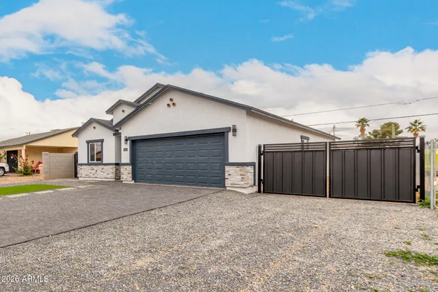 a view of a house with a yard and garage