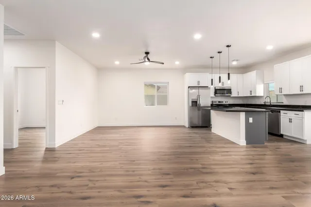 a view of kitchen with granite countertop refrigerator and a sink