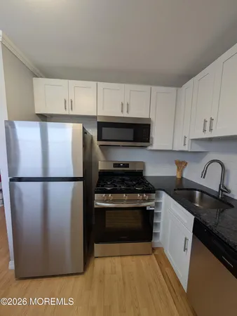 a kitchen with a refrigerator stove and sink