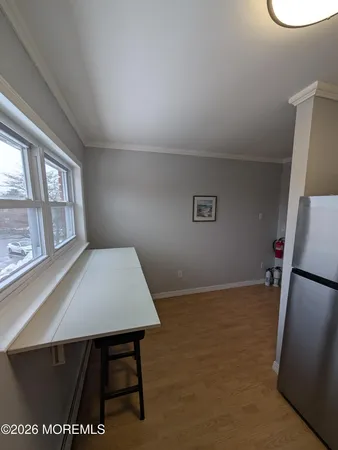 a view of room with window and refrigerator