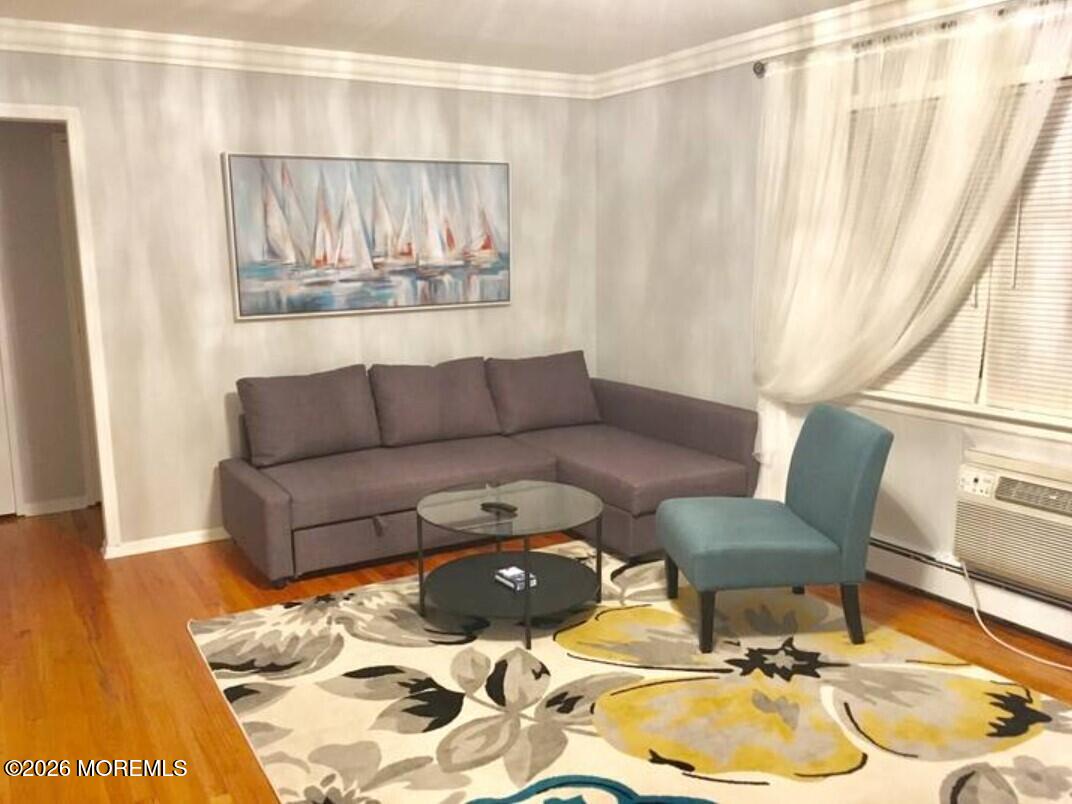 167 Wyckoff Road, Unit B Eatontown, NJ 07724 - Photo 7 of 15 a living room with furniture and a painting on the wall