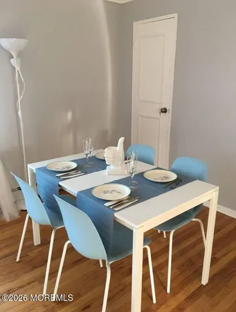 a dining room with furniture and wooden floor