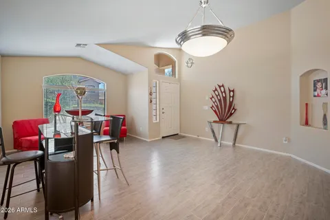 a view of a livingroom with furniture wooden floor and a chandelier
