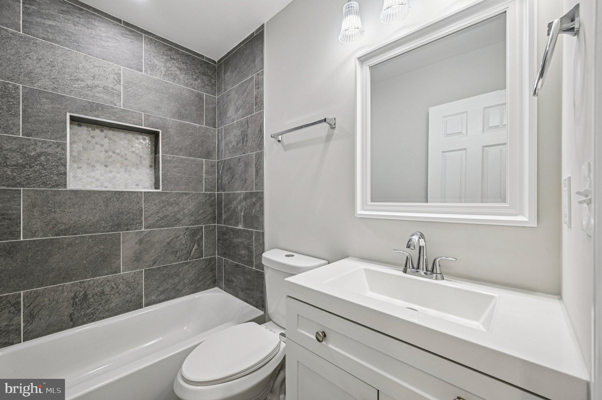 750 Reservoir Street, Unit B Baltimore, MD 21217 - Photo 15 of 25 a bathroom with a sink a toilet and shower