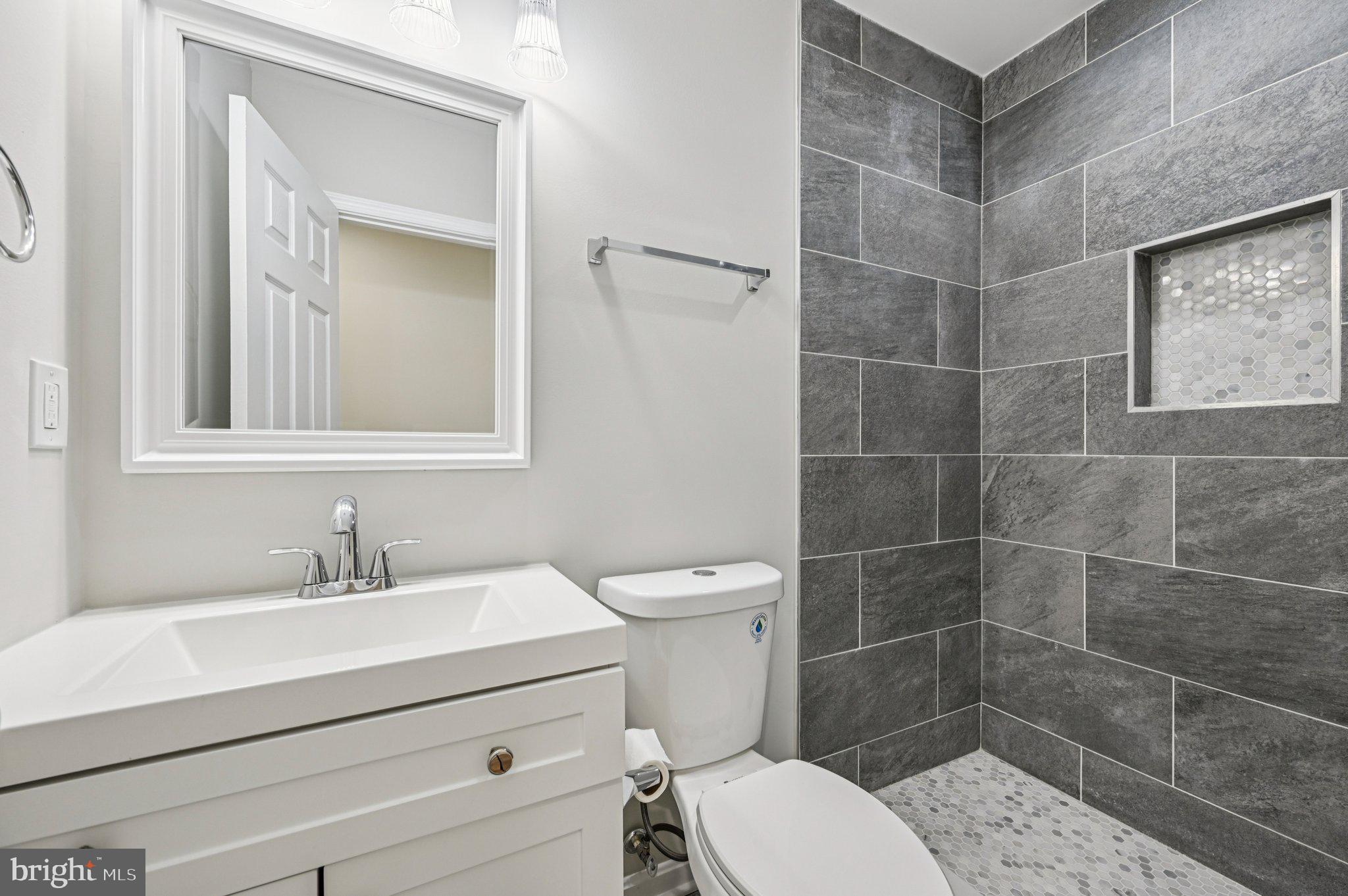 750 Reservoir Street, Unit B Baltimore, MD 21217 - Photo 20 of 25 a bathroom with a sink a toilet and shower