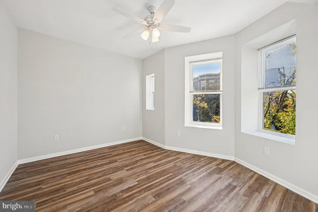 wooden floor in an empty room with a window