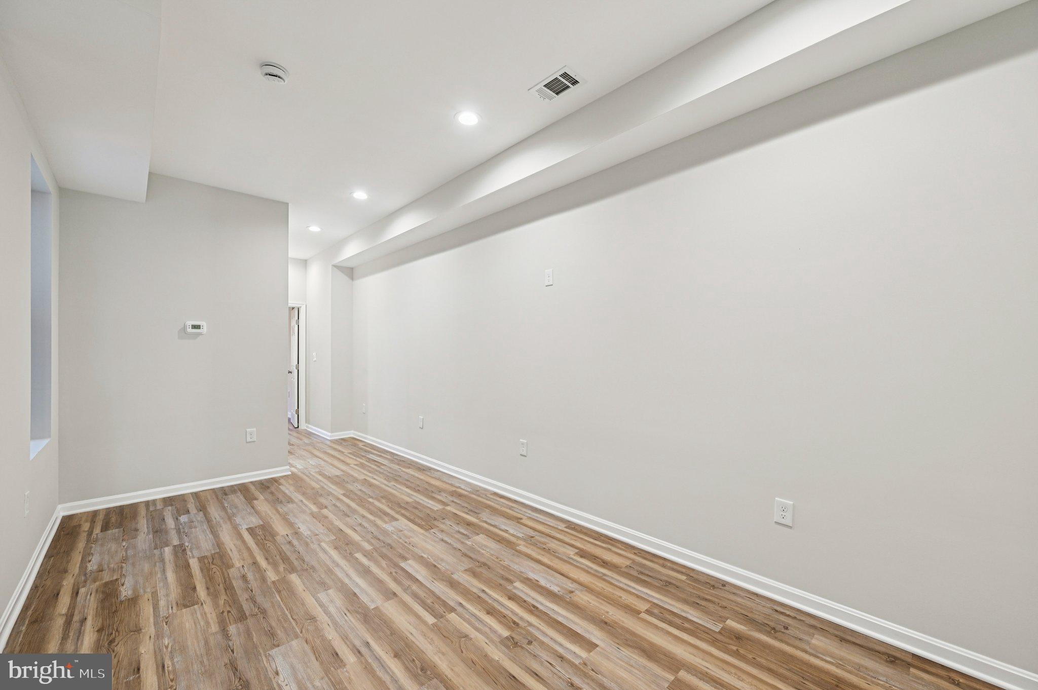 750 Reservoir Street, Unit B Baltimore, MD 21217 - Photo 8 of 25 a view of room with window and wooden floor