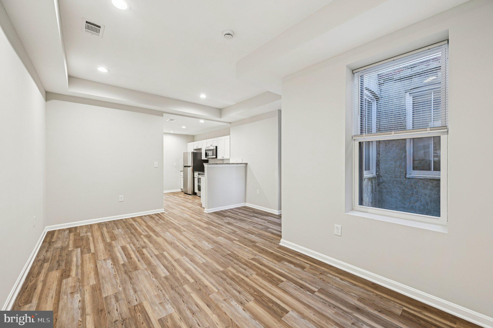 750 Reservoir Street, Unit B Baltimore, MD 21217 - Photo 10 of 25 a view of empty room with wooden floor and window