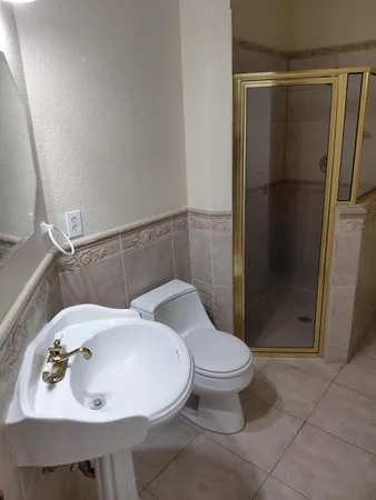 a bathroom with a sink toilet and shower